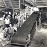 United Parcel Service workers are pictured by the company’s first conveyor belt in 1924. Photo courtesy of UPS archives.