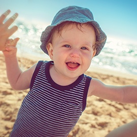 Baby-with-mother-on-the-beach-939848650_6608x4405