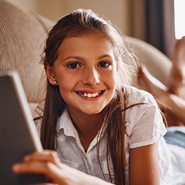 This is my favourite part of the day Full length portrait of a young girl using her tablet while lying on a sofa at home