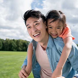 Portrait of a group of young children standing in a line in the hallway of a school