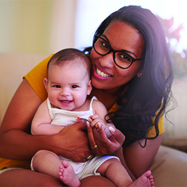 Shot of a young woman relaxing on the sofa with her adorable baby girl at home