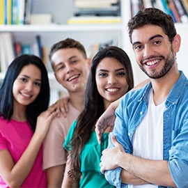 Spanish guy with group of friends in a row indoors at university