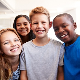 Portrait Of Smiling Male And Female Students In Grade School Classroom