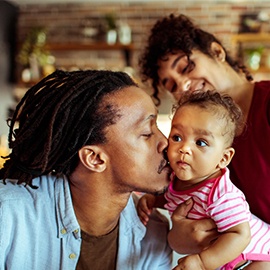 Close up of a young family in their living room using a laptop