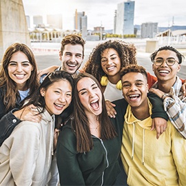 Multiracial group of friends taking selfie picture outdoors - Millennial people having fun on city street - International students smiling together at camera - Youth culture and community concept