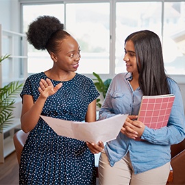 Two women discuss work solutions in boardroom office, mentorship learning Two women discuss work solutions in boardroom office, mentorship learning. High quality photo
