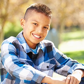 Portrait Of Hispanic Boy In Countryside Smiling To Camera