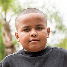 Hispanic Little boy Serious Hispanic little boy looking at the camera embracing